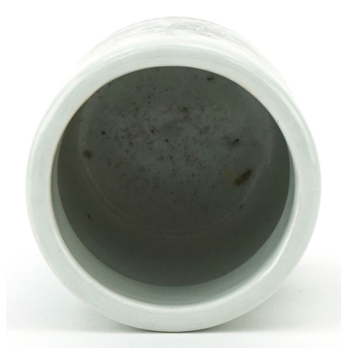 116 - A Chinese porcelain brush pot decorated with mountainous scenery and inscriptions, 11.5cm high.