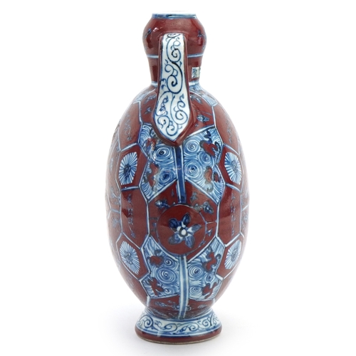 112 - A Chinese porcelain twin handled moon flask hand painted with floral decoration, 31cm high.