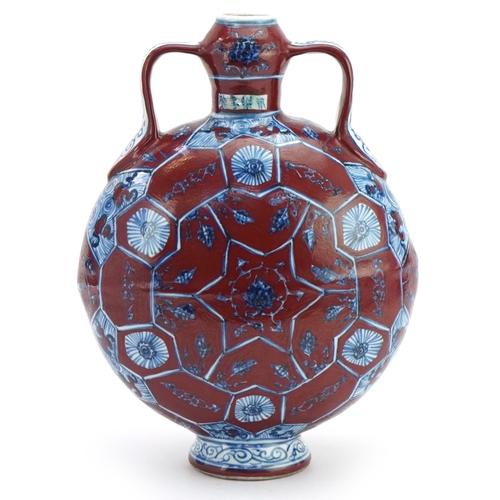 112 - A Chinese porcelain twin handled moon flask hand painted with floral decoration, 31cm high.