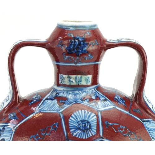 112 - A Chinese porcelain twin handled moon flask hand painted with floral decoration, 31cm high.