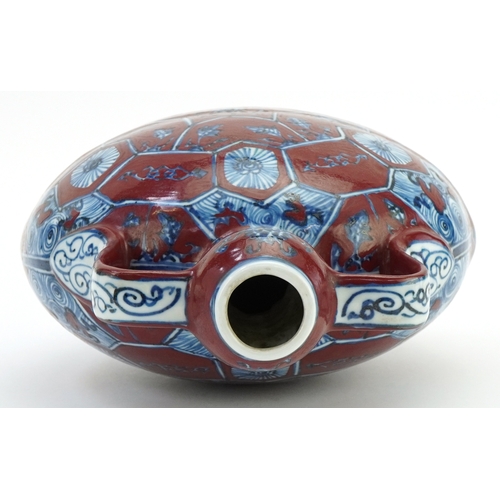 112 - A Chinese porcelain twin handled moon flask hand painted with floral decoration, 31cm high.