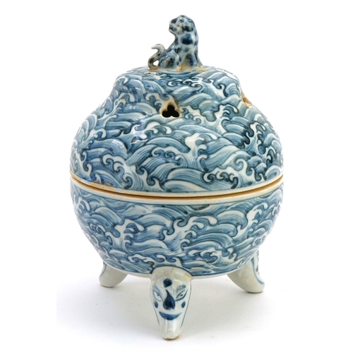 111 - A Chinese blue and white porcelain tripod incense bowl and cover hand painted with masks, crashing w... 