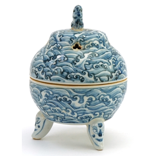 111 - A Chinese blue and white porcelain tripod incense bowl and cover hand painted with masks, crashing w... 