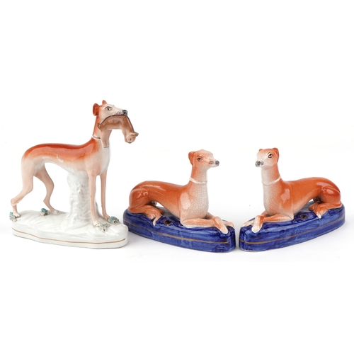 89 - Three Victorian Staffordshire pottery figures of Greyhounds, the largest 20cm high.
