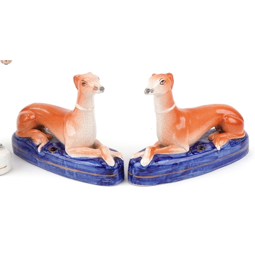 89 - Three Victorian Staffordshire pottery figures of Greyhounds, the largest 20cm high.