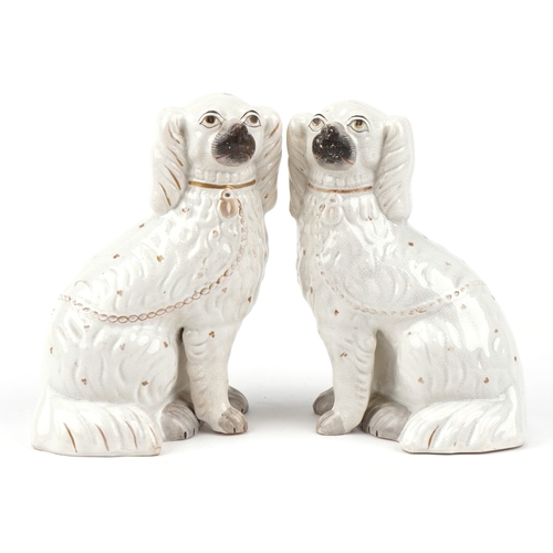 88 - A pair of early 20th century Staffordshire pottery Spaniels, 25cm high.