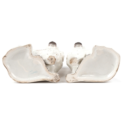 88 - A pair of early 20th century Staffordshire pottery Spaniels, 25cm high.