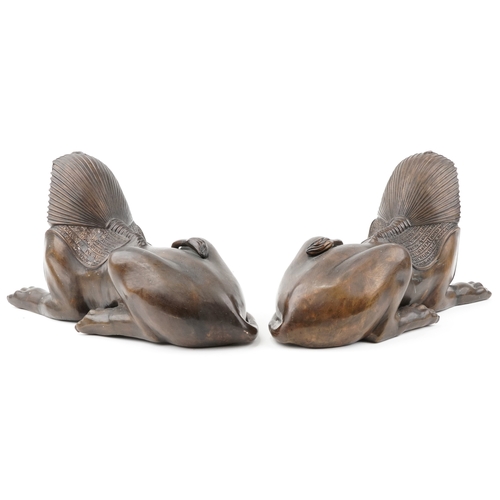 129 - A large pair of decorative bronze models of Egyptian sphynx, 33cm H x 59cm L x 38cm D.