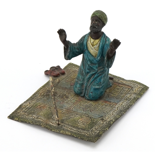 After Franz Xavier Bergmann, a 20th century patinated bronze study of an Arab gentleman praying, 14.5cm in length.
