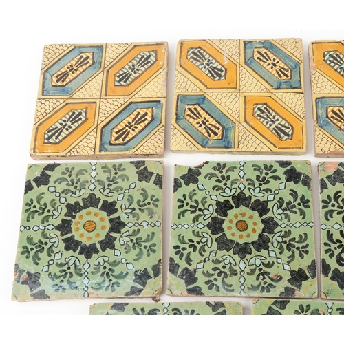 97 - Seven Moroccan hand painted pottery tiles and four similar tiles, 20cm x 20cm.