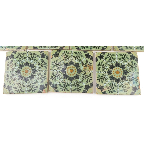 97 - Seven Moroccan hand painted pottery tiles and four similar tiles, 20cm x 20cm.