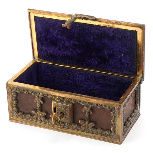74 - An antique German leatherette jewellery casket with brass mounts, 17cm wide.