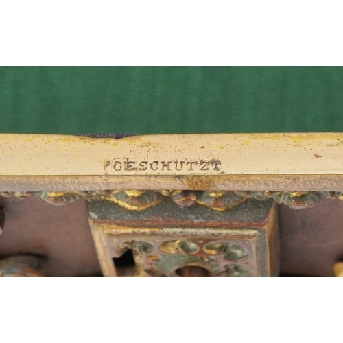 74 - An antique German leatherette jewellery casket with brass mounts, 17cm wide.