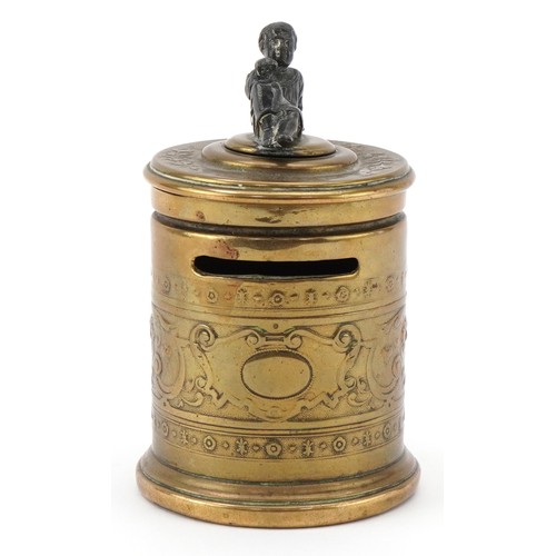 75 - A Grand Tour style brass moneybox with embossed neo-classical decoration and white metal mount in th... 