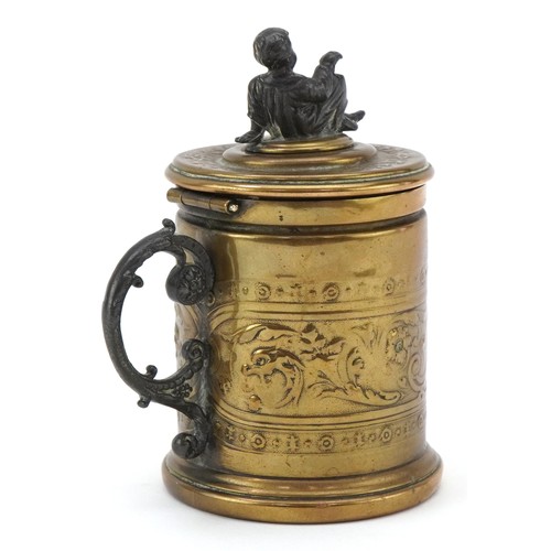 75 - A Grand Tour style brass moneybox with embossed neo-classical decoration and white metal mount in th... 