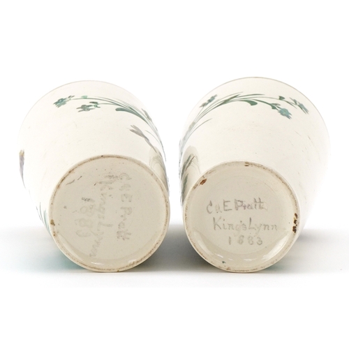 90 - A pair of Prattware beakers hand painted with foliage and butterflies, inscribed C & E Pratt, King's... 