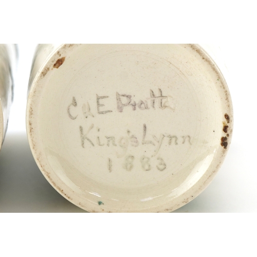 90 - A pair of Prattware beakers hand painted with foliage and butterflies, inscribed C & E Pratt, King's... 