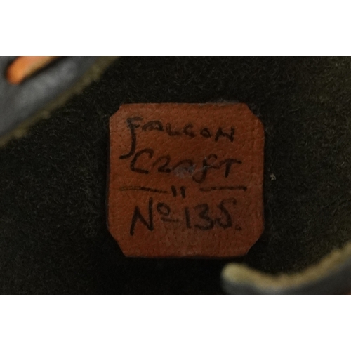 83 - Eleven vintage leather and fabric bird of prey falconry hoods, some with labels to the interior incl... 