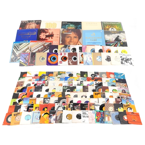 A collection of vinyl LP box sets and 45rpm records.