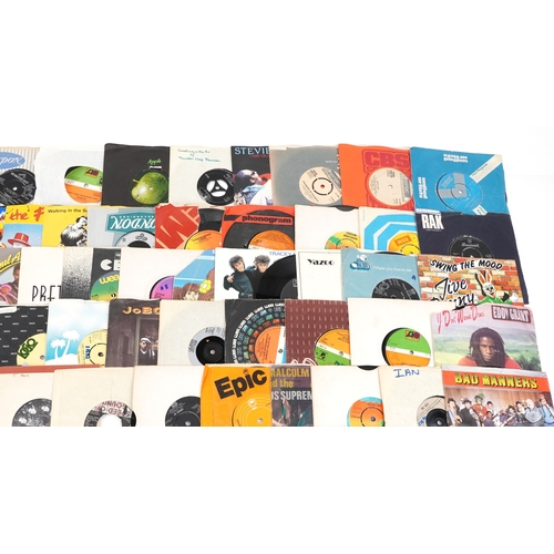 A collection of vinyl LP box sets and 45rpm records.