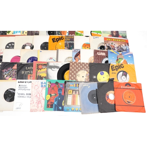 A collection of vinyl LP box sets and 45rpm records.