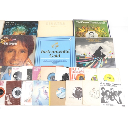 A collection of vinyl LP box sets and 45rpm records.