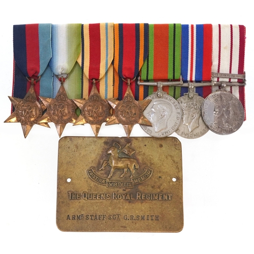 Six British military World War II medals with ribbons and a Naval General Service medal awarded to LT.CDR.R.L.EDWARDS.R.N, with Cyprus bar and a Queen's Royal Regiment brass plaque engraved ARMR Staff Sergeant GR Smith.