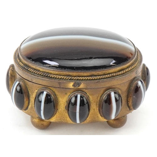 52 - A late 19th century brass jewellery casket set with Scottish agate cabochons, the hinged lid reveali... 