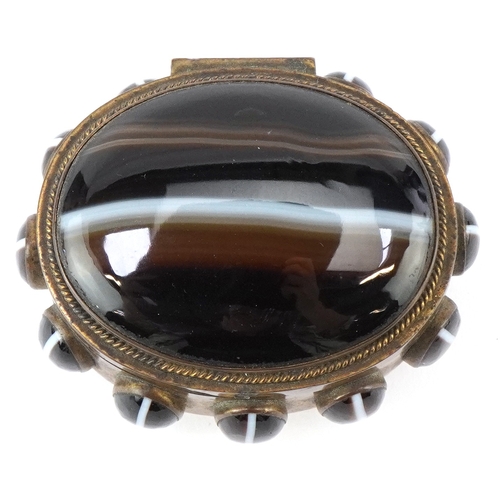 52 - A late 19th century brass jewellery casket set with Scottish agate cabochons, the hinged lid reveali... 