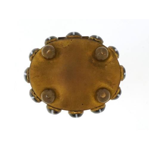 52 - A late 19th century brass jewellery casket set with Scottish agate cabochons, the hinged lid reveali... 