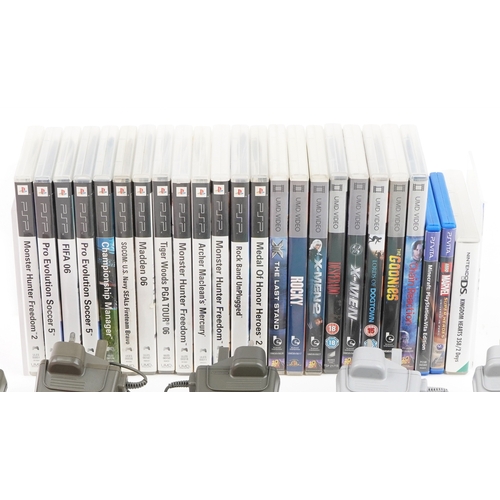 A collection of hand held games consoles with games and accessories ...