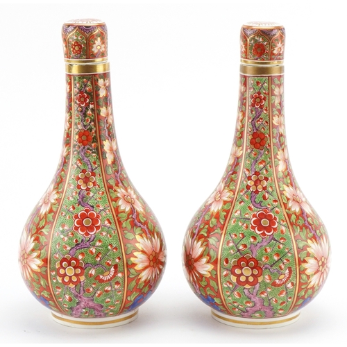 40 - A pair of late 18th/early 19th century Derby porcelain bottleneck vases with covers, each with hand ... 
