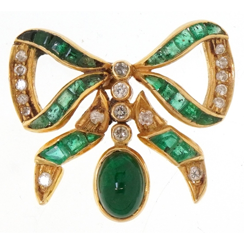 An 18ct gold emerald and diamond bow design pendant, 2.4cm wide, 4.6g.