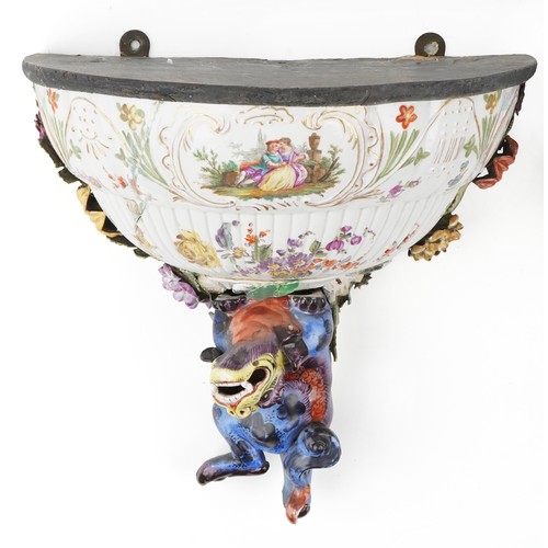 226 - A pair of Continental porcelain wall brackets with Chinese dogs of Foo supports hand painted with co... 