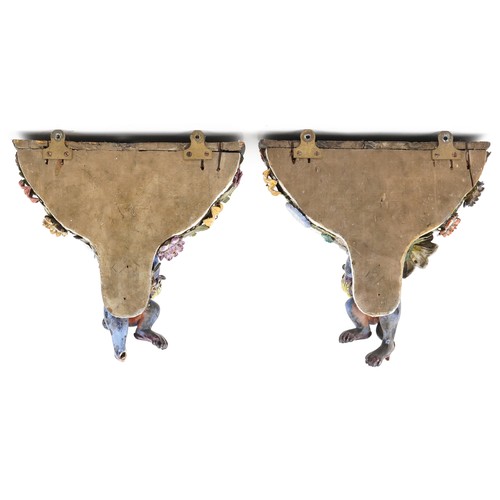 226 - A pair of Continental porcelain wall brackets with Chinese dogs of Foo supports hand painted with co... 
