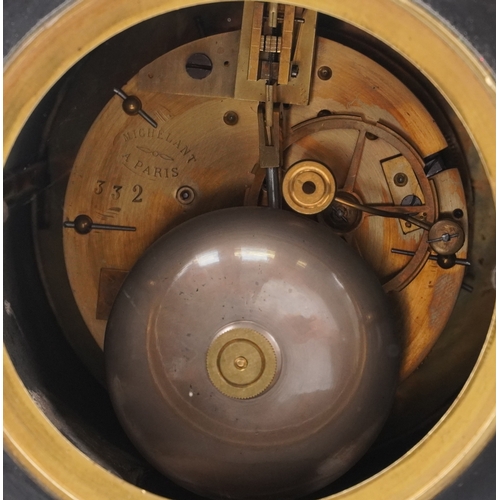 11 - A Victorian slate and green marble clock garniture, the circular black enamelled dials with Roman nu... 