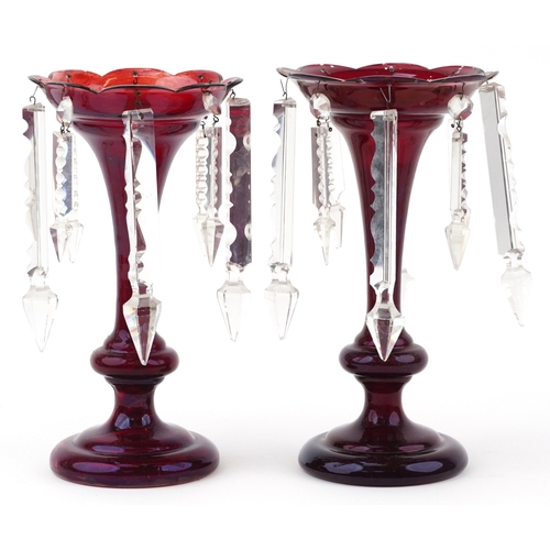 42 - A pair of Victorian cranberry glass table lustres with cut glass drops, 26cm high.