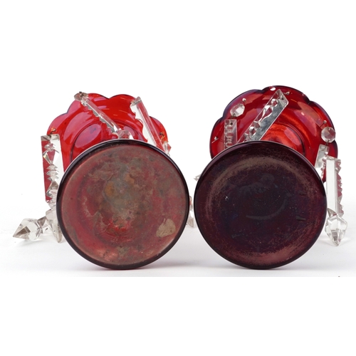 42 - A pair of Victorian cranberry glass table lustres with cut glass drops, 26cm high.