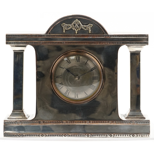 16 - A silver plated copper mantle clock having silvered dial with Roman numerals, the dial with indistin... 