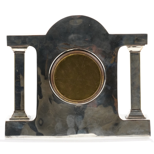 16 - A silver plated copper mantle clock having silvered dial with Roman numerals, the dial with indistin... 
