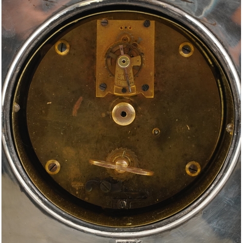 16 - A silver plated copper mantle clock having silvered dial with Roman numerals, the dial with indistin... 