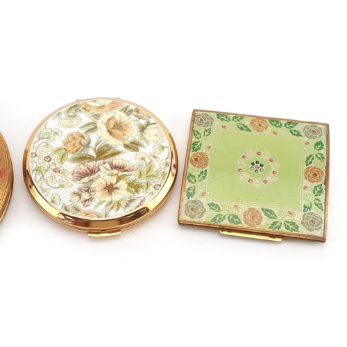 Four vintage compacts including Stratton, the largest 9.5cm in diameter.