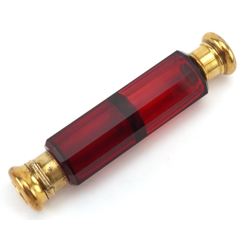 44 - A Victorian double ended faceted ruby glass scent bottle with silver gilt mounts, retailed by Baxter... 