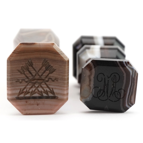 48 - Two agate intaglio seals engraved with arrows and initials, the largest 6.8cm high.