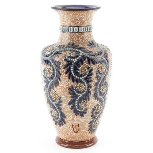56 - George Tinworth for Royal Doulton, an Art Nouveau stoneware vase hand painted with stylized flowers,... 