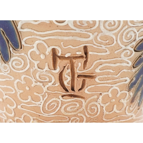 56 - George Tinworth for Royal Doulton, an Art Nouveau stoneware vase hand painted with stylized flowers,... 