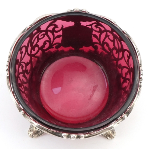 A Victorian pierced silver open table salt raised on four feet having a ...
