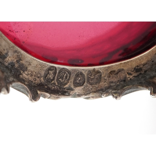A Victorian pierced silver open table salt raised on four feet having a ...