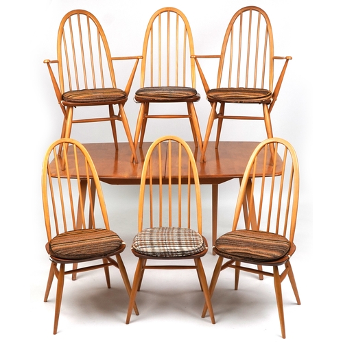 An Ercol elm and beech rectangular extending dining table, 72cm H x 152cm W x 88cm D together with six hoop back dining chairs comprising two carvers and two standard.