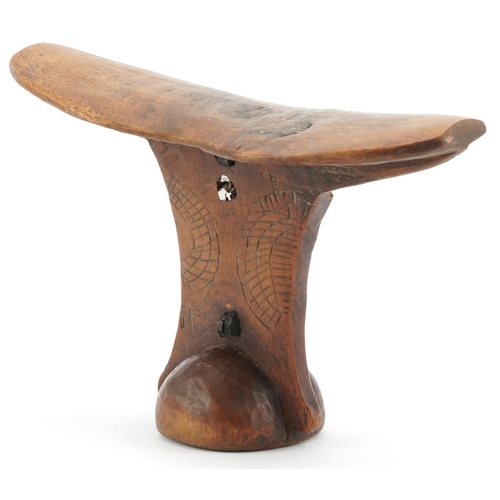 An African tribal 'Turkana' wooden headrest with carved decoration, 15cm high.